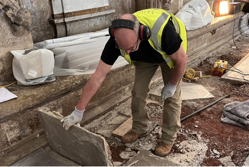 a construction man digging up concrete